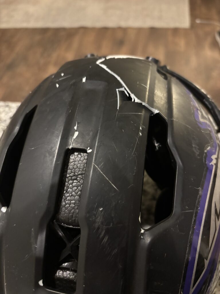 Image of the Apache Lightning Youth Football Helmet that was cracked and damaged at football practice.